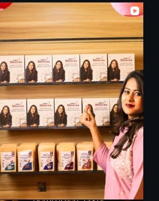 RJ Keerthi in front of Kiki's Bhuvaa Display Shelves